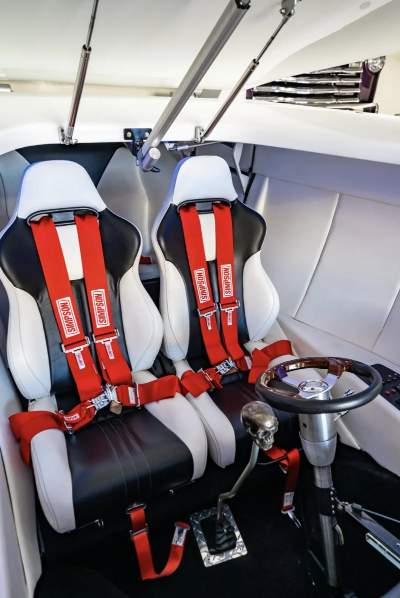 The Toilet Car's cabin with red-harness seats