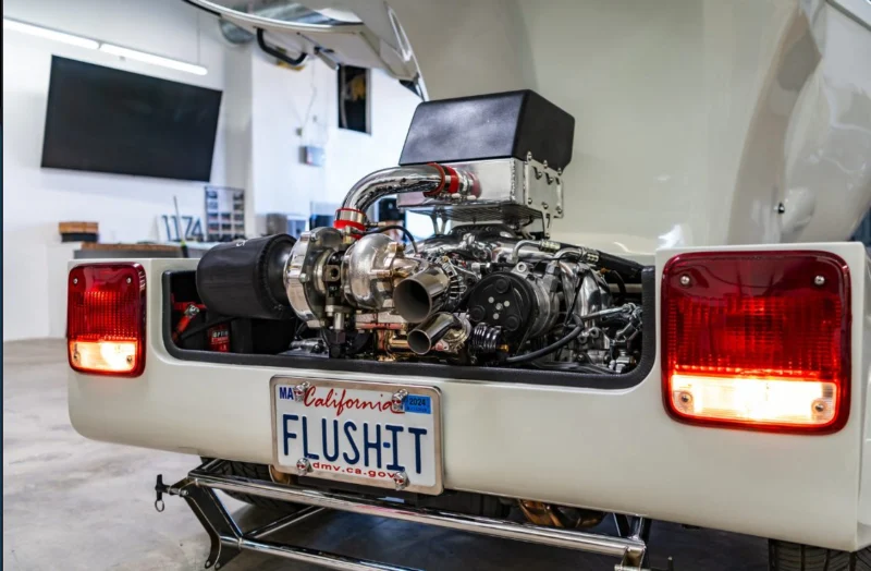 The Toilet Car's rear with its exposed engine and FLUSHIT California plate
